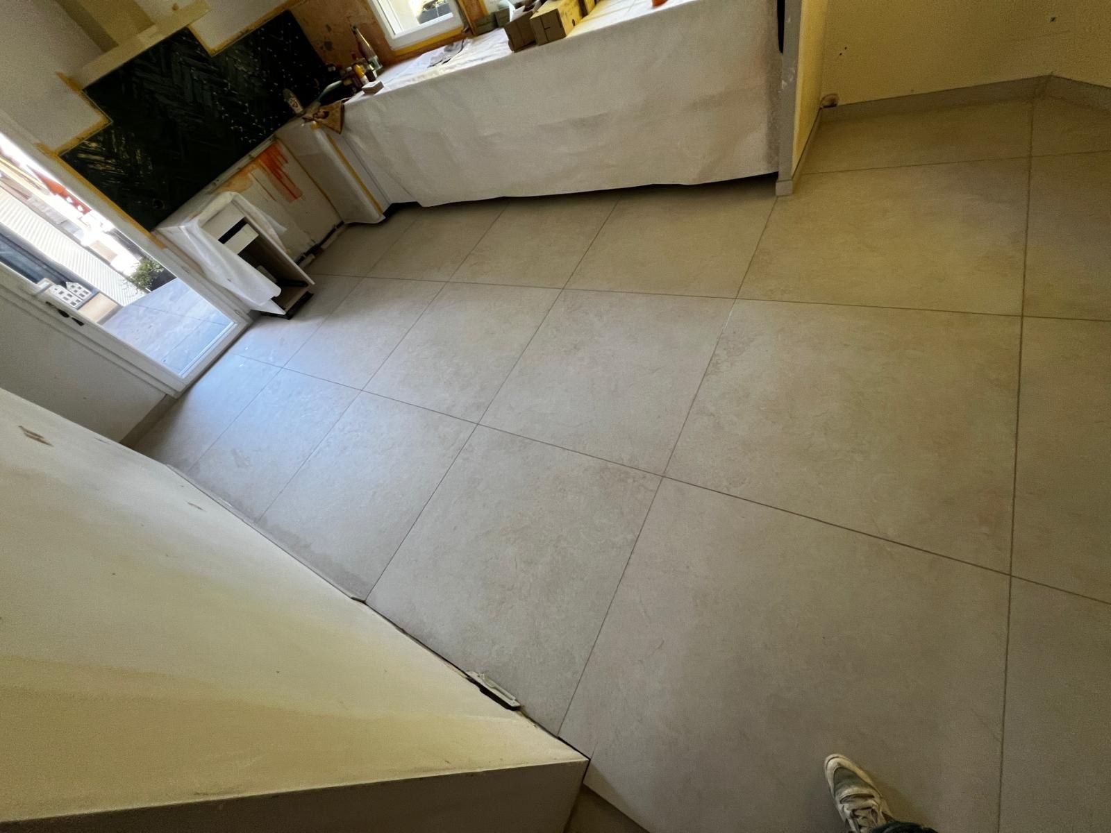 Carrelage grand format clair se prolongeant du séjour jusqu’à la cuisine